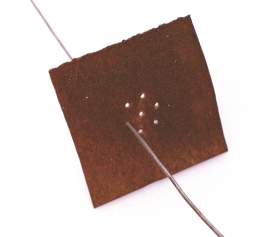 Metal plate with 7 holes for twisting smaller wire into wire rope.