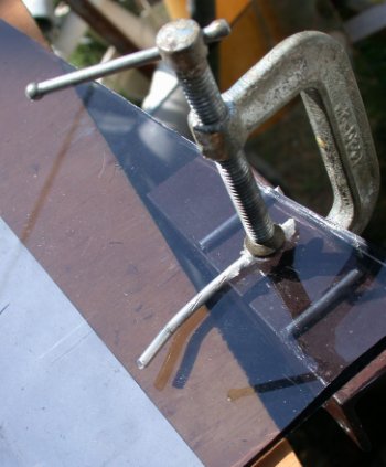 Glass cracking tool from C-clamp, wire and angle.
