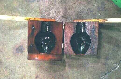 Wood mold for making a vase or pitcher shape.