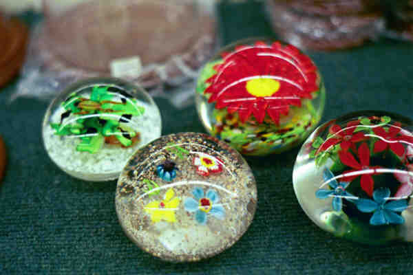 Group of four commercial paperweights