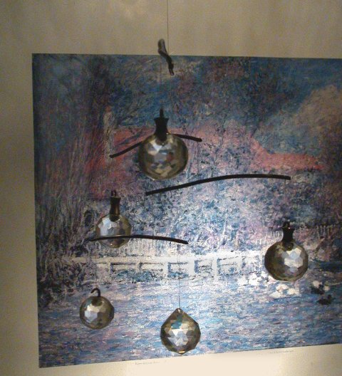 Mobile made of cut crystal sphere knobs and ornaments hung on heavy copper wire