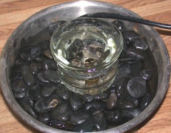 Glass bowl drilled in bottom for burble over fountain.