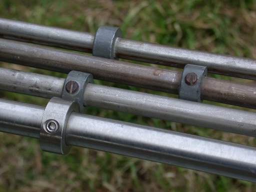Shaft collars on pipes and punty, closeup