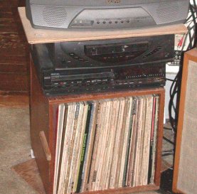 Phonograph records in modular cube on swivel with TV & VCR